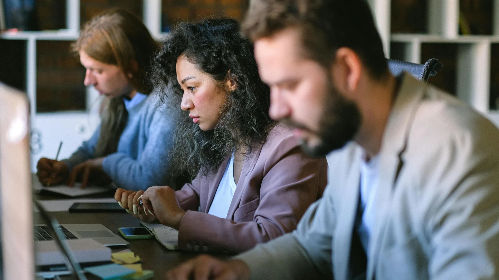 An editorial team working through a document set together